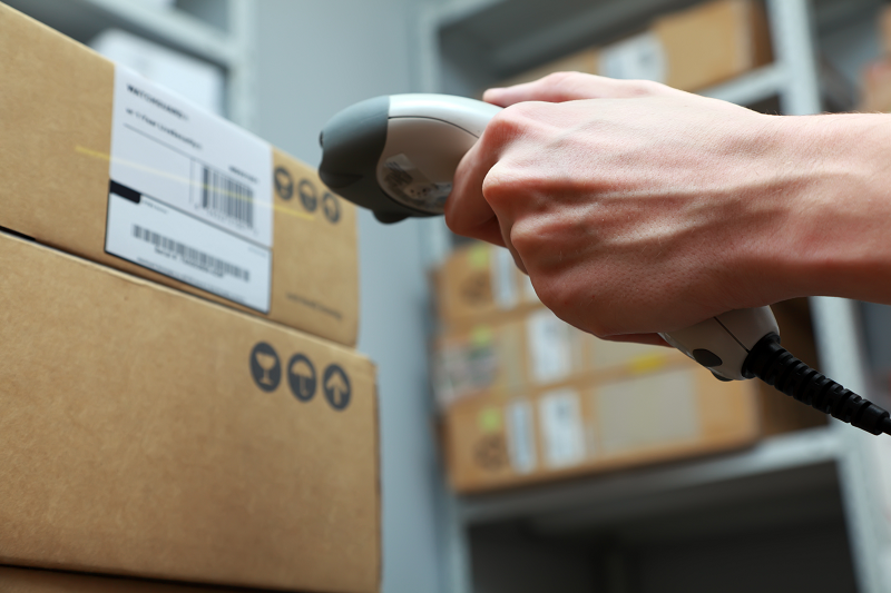 Warehouse worker scanning package eCommerce Shipping Solution